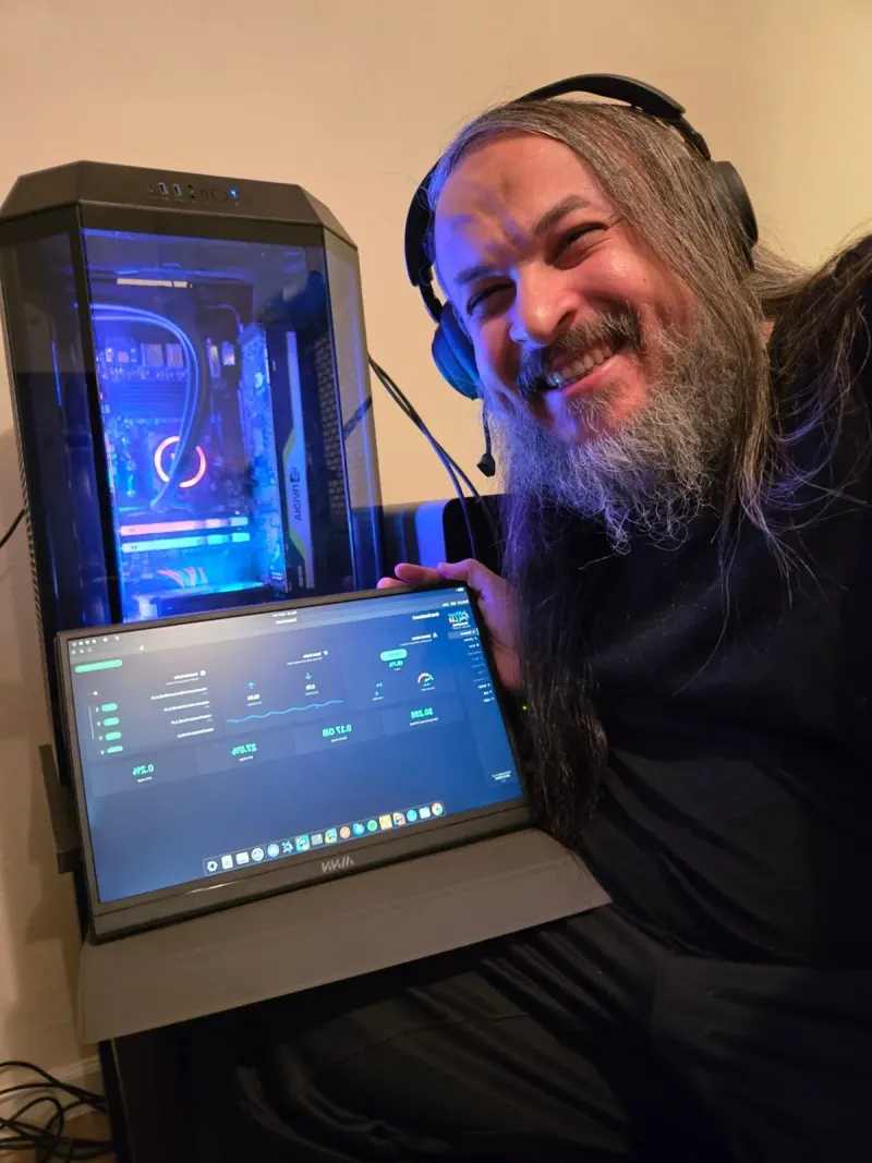 One happy engineer, one glowing rig, one PeerLLM host dashboard.