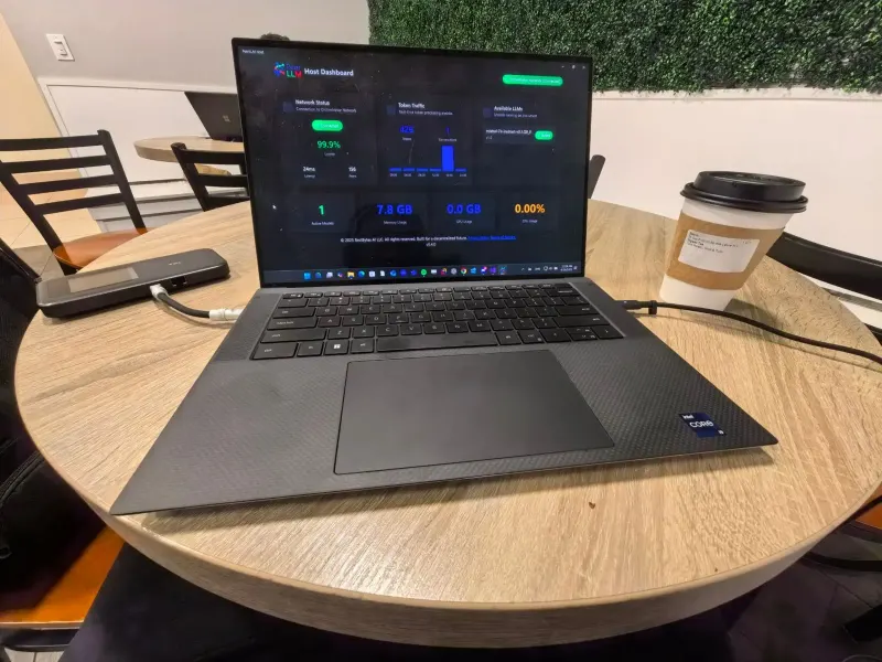 Serving tokens from a café table — laptop, hotspot, and an organic tea.